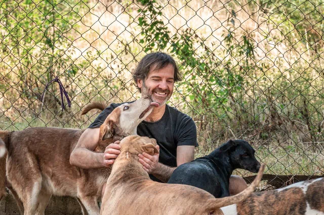Sanctuary owner playing with dog