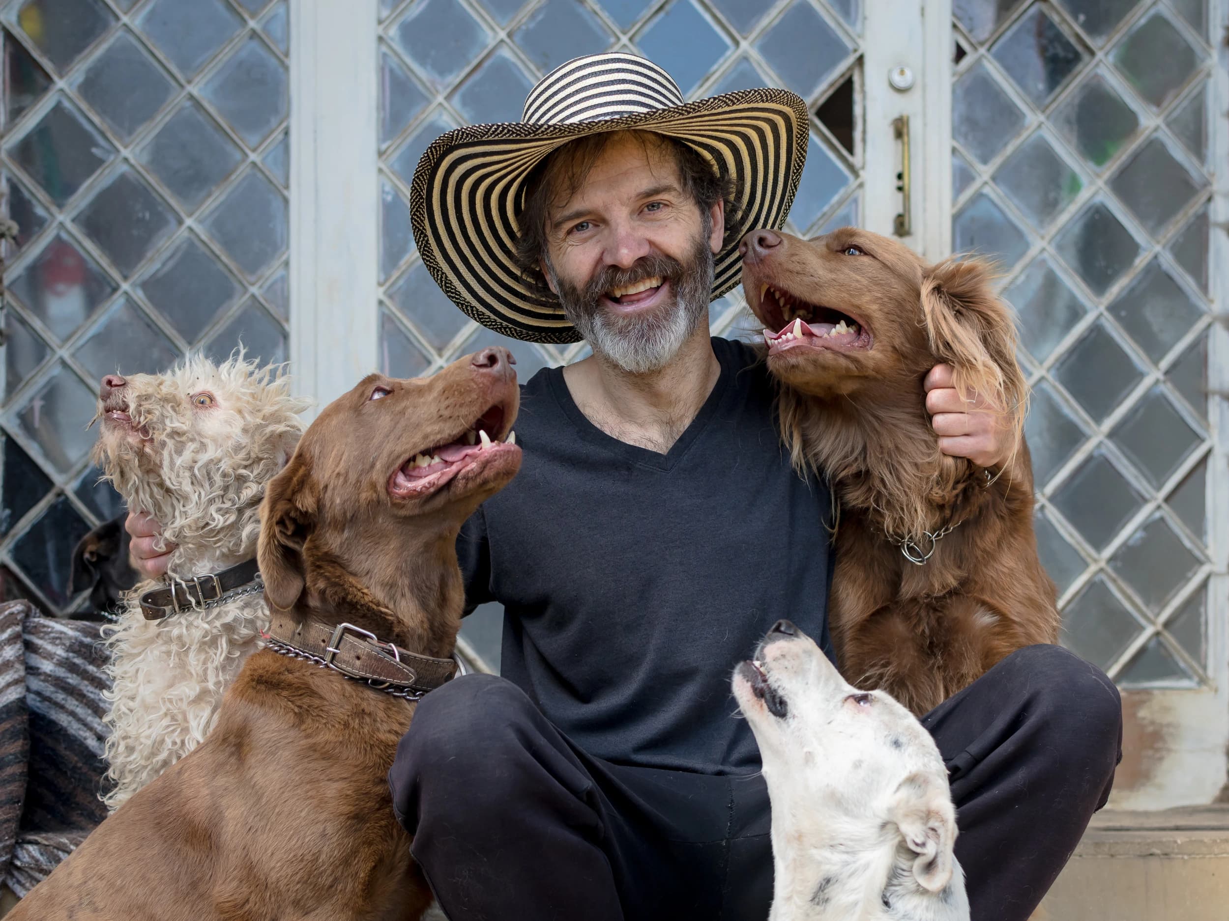 Founder of Animal Shepherd with rescued dogs